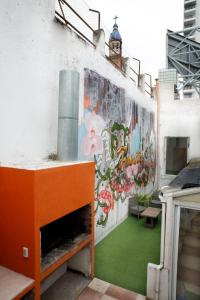 a building with a mural on the side of it at Real Ros Hostel in Rosario