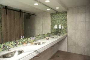 a bathroom with three sinks and a large mirror at Real Ros Hostel in Rosario +20 photos