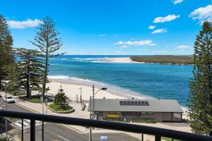 a view of a beach and a building at Cerulean Apartments in Caloundra