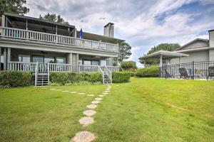 a house with a walkway in front of a yard at Balcony and Lake Access Hot Springs Getaway! in Hot Springs