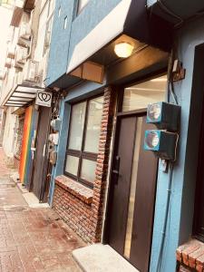 a building with a door on a city street at 田町包棟旅宿TAMACHI Inn in Tainan