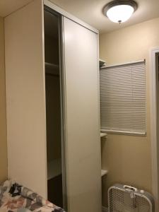 a bedroom with a glass closet with a fan at New bedroom queen size bed at Las Vegas for rent-2 in Las Vegas