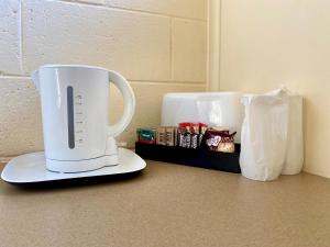 a white coffee maker sitting on top of a counter at Rye Beach Motel Australia in Rye