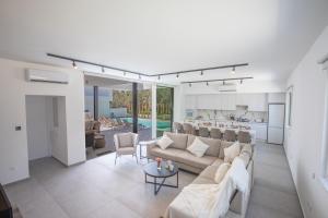 a living room with a couch and a kitchen at Kube Luxury Villas in Ayia Napa
