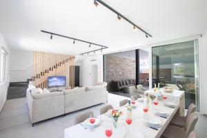 a living room with white tables and chairs at Kube Luxury Villas in Ayia Napa