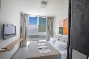a hotel room with a bed with towels on it at Kube Luxury Villas in Ayia Napa