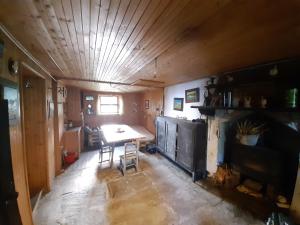 a room with a table and a fireplace in a house at La Baita di Heidi in Craveggia