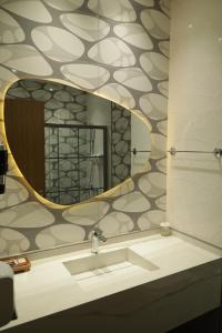 a bathroom with a mirror and a sink at Sirin Park Hotel in Adana