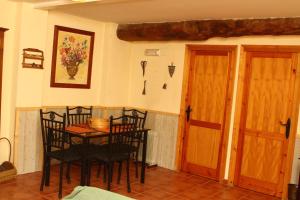 uma sala de jantar com uma mesa e cadeiras e uma porta em Rural puebla de san miguel em Puebla de San Miguel