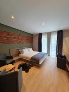a bedroom with a bed and a table and chairs at ALEGRIA - MOIECIU DE SUS in Moieciu de Sus