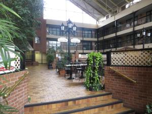 a courtyard with tables and chairs in a building at Clifton Victoria Inn at the Falls in Niagara Falls