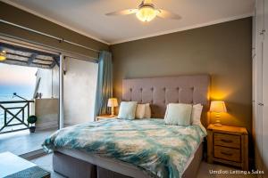 a bedroom with a bed with a view of the ocean at 8 Waterfront in Umdloti