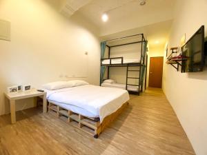 a bedroom with a bed and a bunk bed at Stay Liuqiu Diving Hostel in Xiaoliuqiu