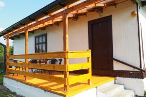 a porch of a house with a table and chairs at Agroturystyka u Grażki in Szostakowo +8 photos