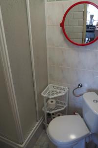 a small bathroom with a toilet and a mirror at Agroturystyka u Grażki in Szostakowo