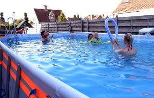 um grupo de pessoas brincando em uma piscina em Chambre d'hôte Blankenberge em Blankenberge