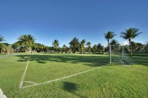 a grassy field with a tennis court at Hotel Deville Prime Salvador in Salvador