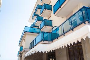 a building with blue balconies on the side of it at Hotel Souvenir in Lido di Jesolo