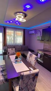 a kitchen and living room with a table and chairs at Bálint & Timi wellness apartman in Siófok