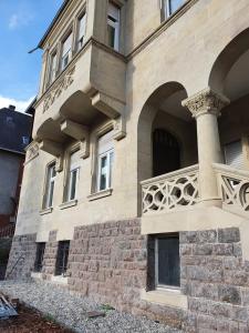 a large building with a staircase on the side of it at Boutique Hotel Villa Horbach in Idar-Oberstein