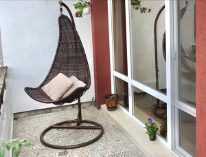 a wicker swing chair sitting on a porch at Yanov's Homestay in Varna City