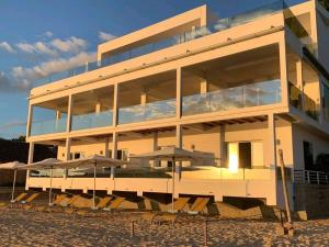 贝岛Etoile Blanche的前面有桌子和伞的建筑