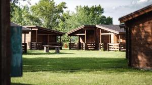a group of buildings with a picnic table in the grass at Camping Divoká Voda in Bratislava