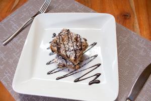 a piece of cake on a white plate on a table at Elmer Resort & Spa Naivasha in Naivasha