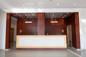 a lobby with a large reception desk in a building at Pushkara Sarovar Portico in Dibrugarh
