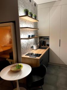 a small kitchen with a table and a counter at Golden Key Apartments in Liberec
