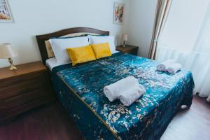 a bedroom with a bed with towels on it at RELAX Apartments in HASKOVO, Apt1 in Haskovo