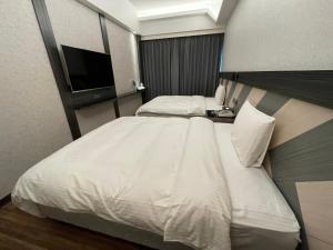 En eller flere senger på et rom på Weifeng Boutique Business Hotel - Zhanqian Branch