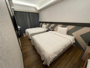 En eller flere senger på et rom på Weifeng Boutique Business Hotel - Zhanqian Branch