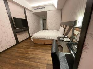 En eller flere senger på et rom på Weifeng Boutique Business Hotel - Zhanqian Branch