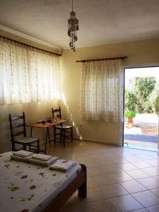 a bedroom with a table and a bed and a dining room at Vrachos Sunrise Apartment in Vrachos