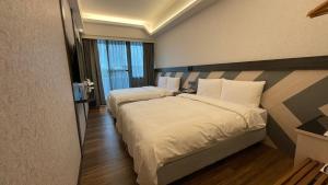 En eller flere senger på et rom på Weifeng Boutique Business Hotel - Zhanqian Branch