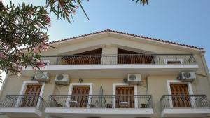 a large white building with balconies on it at Papadatos Studios in Argostoli