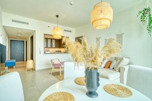a living room with a table and a couch at Boho-Chic Cosy 1BR, minutes to Burj Khalifa in Dubai