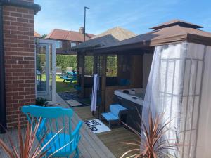 un patio avec un parasol et des chaises sur une terrasse dans l'établissement Beautifully presented 6 bed 5 & a half bath house, à Newcastle upon Tyne