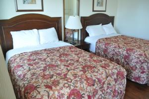 a hotel room with two beds and a lamp at Spindrift Motel in Ocean City