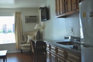 a kitchen with a sink and a living room at Spindrift Motel in Ocean City