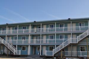 an apartment building with white balconies and stairs at Spindrift Motel in Ocean City