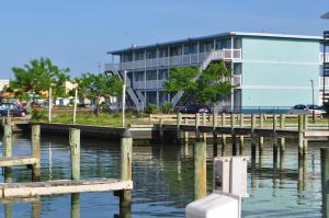 a dock in the water next to a building at Spindrift Motel in Ocean City +12 photos