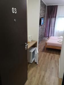 a door to a room with a bed and a bedroom at Apartman 25 in Belgrade