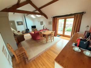 a living room with a table and a couch at Bryn Teg Barn in Dyffryn