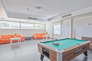 a living room with a pool table in it at Hotel Balneario Playa de Comarruga in Comarruga