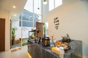 a kitchen with a counter top with a stove at Villa White House Batu in Batu