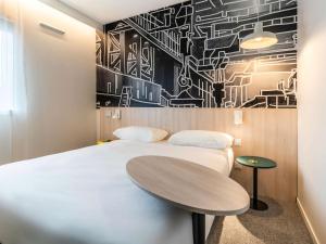 Postel nebo postele na pokoji v ubytování ibis Styles Limoges Centre