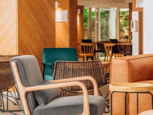 a group of chairs and tables in a room at ibis Styles Golden Sands Roomer Hotel in Golden Sands