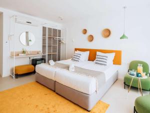 a bedroom with a large bed and two chairs at ibis Styles Golden Sands Roomer Hotel in Golden Sands